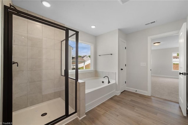 5751 Siler St, Trinity, NC 27370 - full bath with plenty of natural light, wood finished floors, a bath, and a shower stall