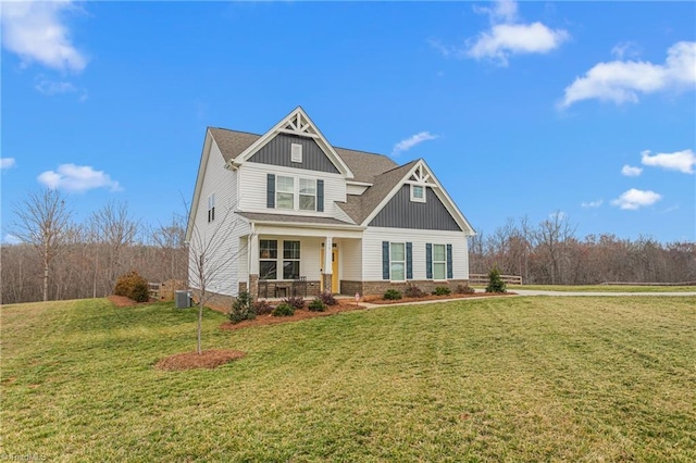 craftsman inspired home featuring a front yard, central air condition unit, covered porch, and board and batten siding