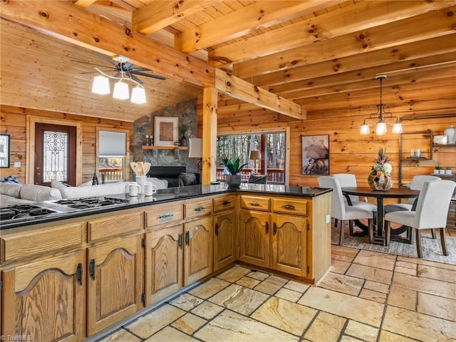 kitchen featuring wood ceiling, ceiling fan, kitchen peninsula, and wooden walls