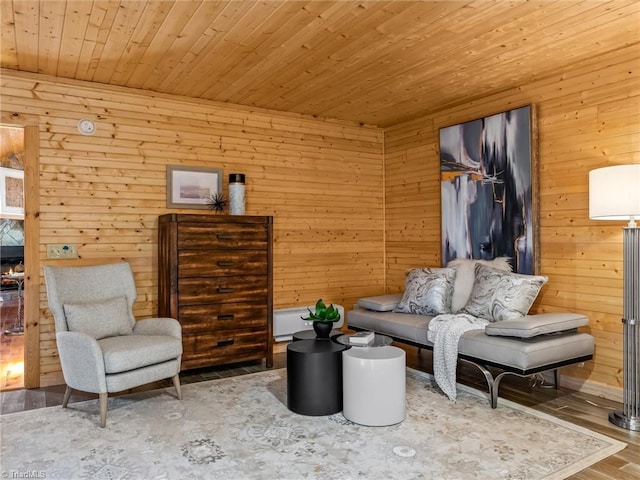 living room featuring a fireplace, hardwood / wood-style flooring, wood ceiling, and wood walls