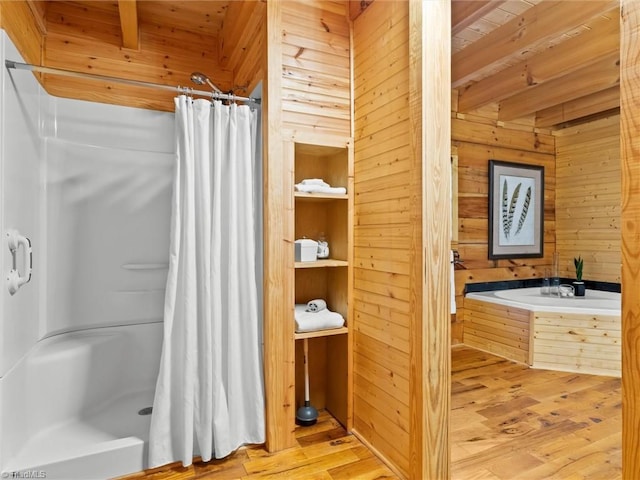 bathroom with hardwood / wood-style floors, wood walls, wooden ceiling, independent shower and bath, and beamed ceiling