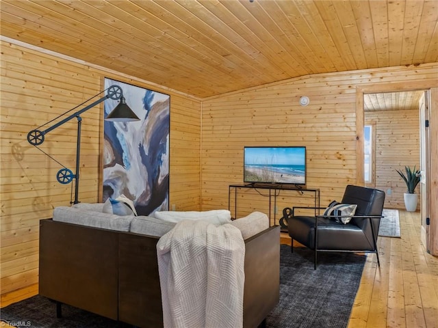 living room featuring hardwood / wood-style floors, wooden walls, lofted ceiling, and wood ceiling