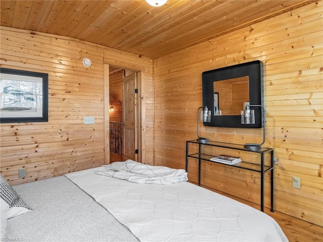 carpeted bedroom with wooden walls and wood ceiling