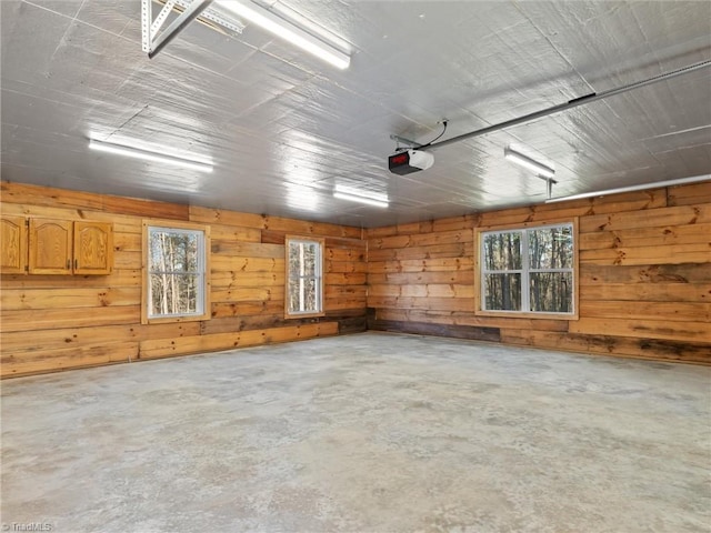 garage with wooden walls and a garage door opener