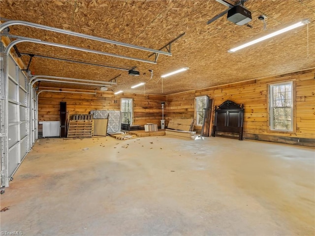 garage featuring wooden walls and a garage door opener