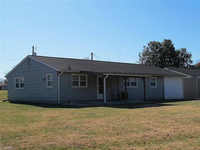 rear view of house featuring a lawn