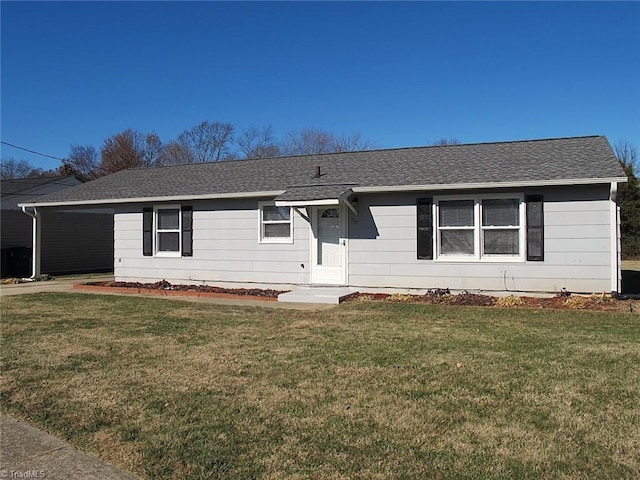 ranch-style house featuring a carport and a front lawn