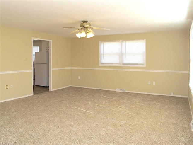 empty room with carpet flooring and ceiling fan