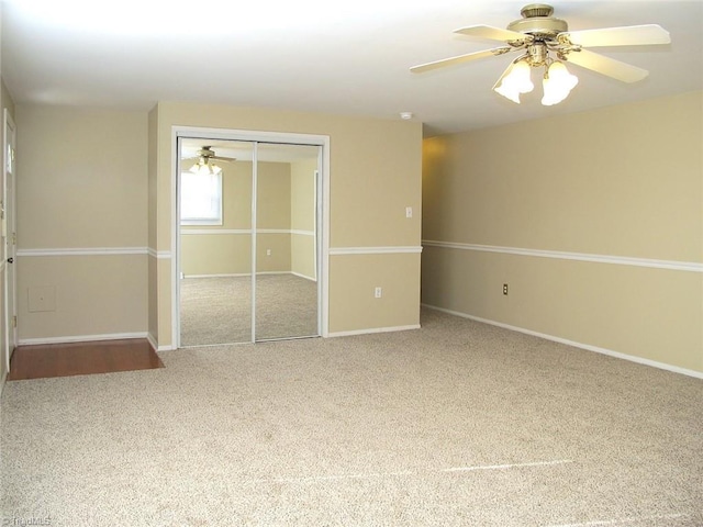 unfurnished bedroom featuring carpet floors, a closet, and ceiling fan