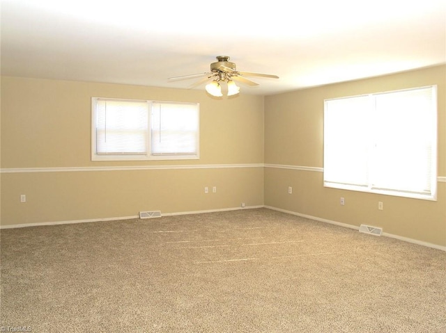 spare room with carpet and ceiling fan