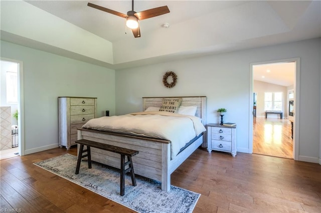 bedroom featuring baseboards, ceiling fan, lofted ceiling, and wood-type flooring