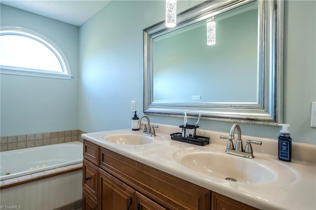 full bath with a sink, a tub with jets, and double vanity