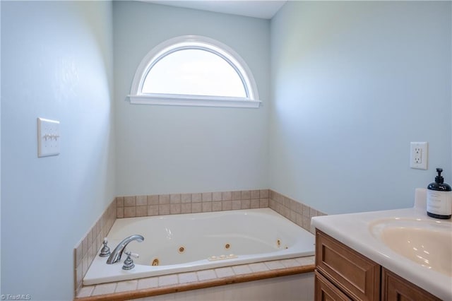 bathroom with a jetted tub and vanity