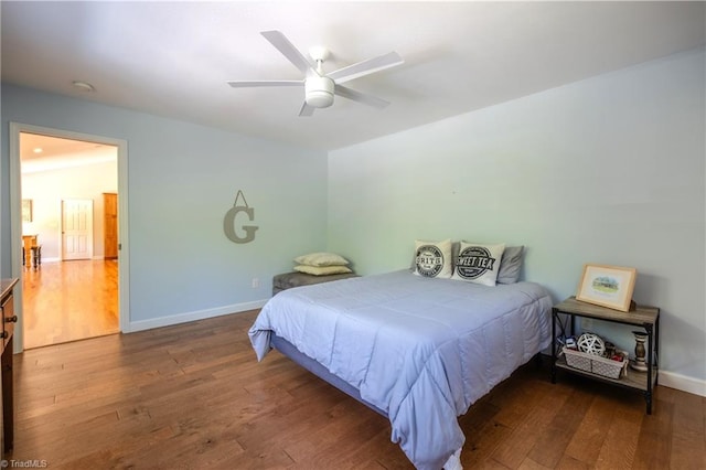 bedroom featuring baseboards, a ceiling fan, and wood finished floors