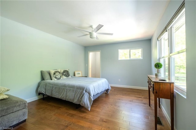 bedroom featuring ceiling fan, wood-type flooring, and baseboards