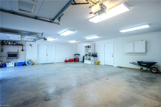 garage with baseboards and a garage door opener