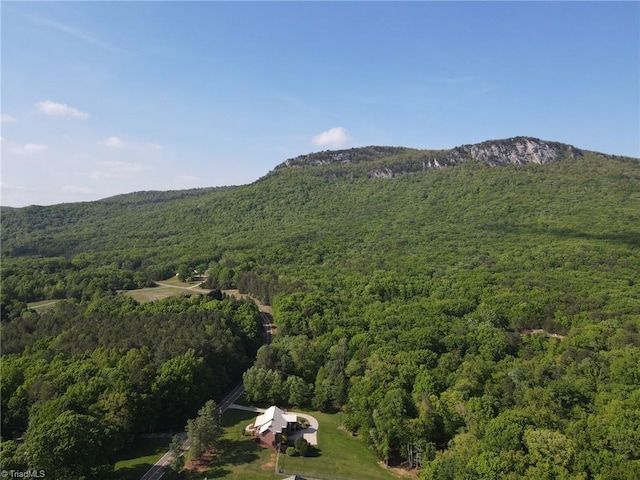 aerial view with a wooded view and a mountain view