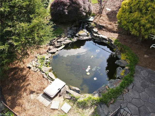 drone / aerial view with a small pond