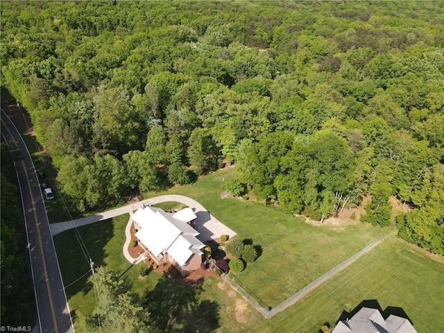 birds eye view of property with a forest view