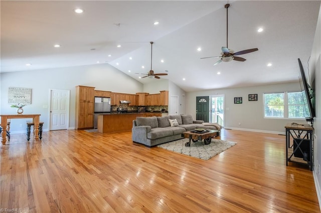living room with light wood finished floors, recessed lighting, ceiling fan, and high vaulted ceiling