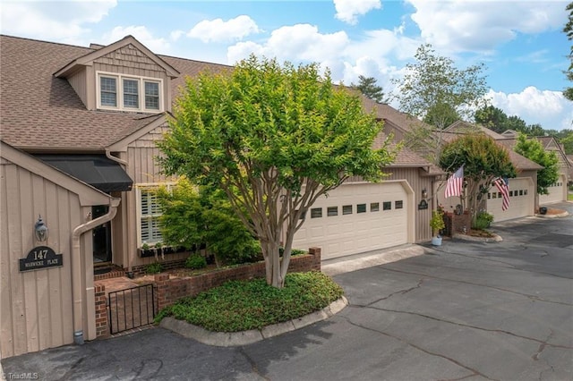 149 Warwicke Pl, Bermuda Run, NC 27006 - obstructed view of property featuring a shingled roof and board and batten siding