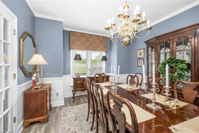149 Warwicke Pl, Bermuda Run, NC 27006 - dining area featuring a wainscoted wall, a chandelier, wood finished floors, and crown molding