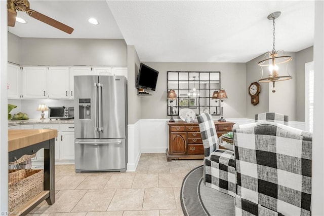 149 Warwicke Pl, Bermuda Run, NC 27006 - kitchen featuring stainless steel refrigerator with ice dispenser, light countertops, a ceiling fan, white cabinets, and wainscoting