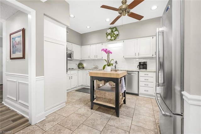 149 Warwicke Pl, Bermuda Run, NC 27006 - kitchen with stainless steel appliances, light countertops, a ceiling fan, decorative backsplash, and white cabinets