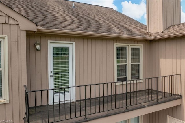 149 Warwicke Pl, Bermuda Run, NC 27006 - view of property exterior featuring roof with shingles, a chimney, and a balcony