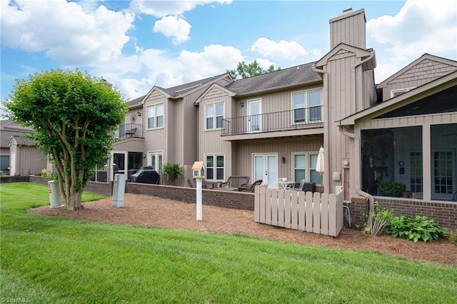 149 Warwicke Pl, Bermuda Run, NC 27006 - back of property with a lawn, a chimney, and a balcony