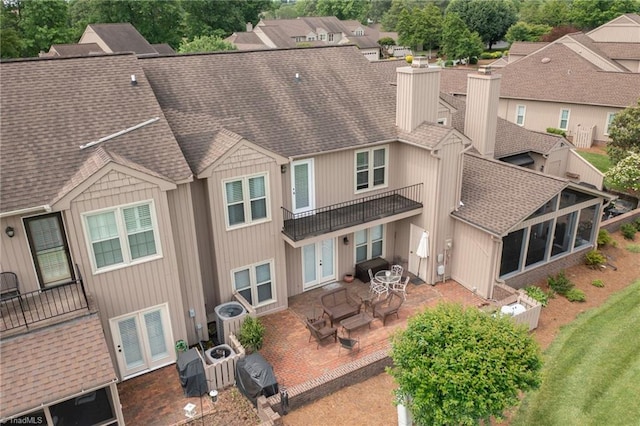 149 Warwicke Pl, Bermuda Run, NC 27006 - back of property featuring roof with shingles, a balcony, a patio area, a chimney, and central AC