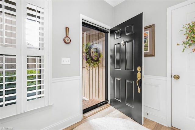 149 Warwicke Pl, Bermuda Run, NC 27006 - entrance foyer featuring plenty of natural light, light wood finished floors, wainscoting, and a decorative wall