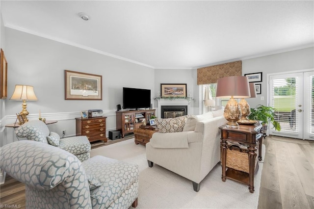 149 Warwicke Pl, Bermuda Run, NC 27006 - living area with ornamental molding, light wood-style flooring, and a glass covered fireplace