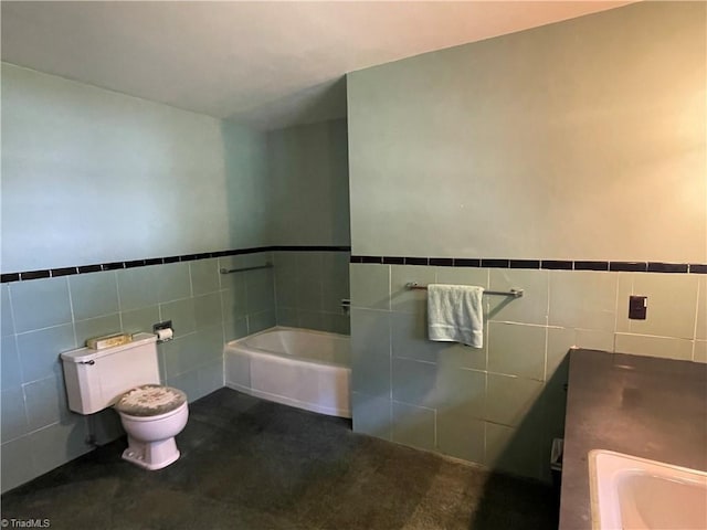 1706 Windsor Dr, High Point, NC 27262 - bathroom featuring tile walls, a bath, toilet, a sink, and a wainscoted wall