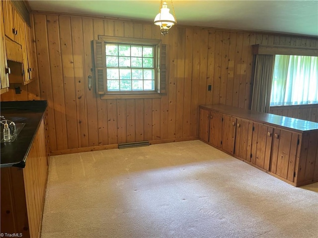 1706 Windsor Dr, High Point, NC 27262 - unfurnished dining area featuring light colored carpet, wood walls, and baseboards