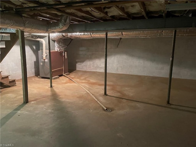 1706 Windsor Dr, High Point, NC 27262 - unfinished basement with heating unit, stairs, and concrete block wall