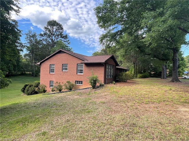 1706 Windsor Dr, High Point, NC 27262 - view of side of home featuring brick siding and a yard