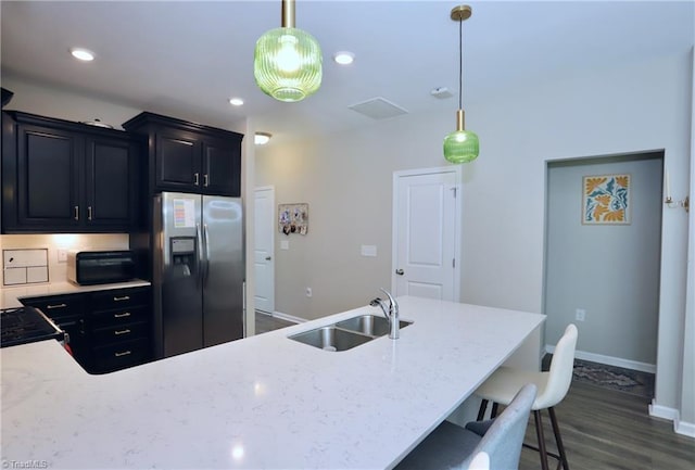 547 Historic Dr, Hillsborough, NC 27278 - kitchen with a sink, a breakfast bar, stainless steel fridge, baseboards, and dark wood-style flooring