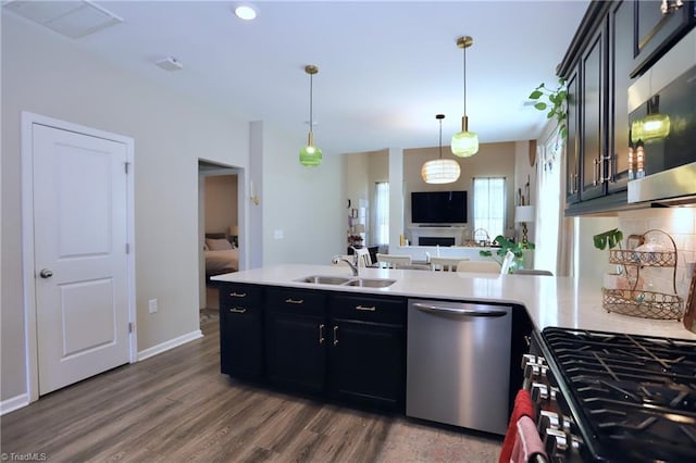 547 Historic Dr, Hillsborough, NC 27278 - kitchen with stainless steel appliances, light countertops, wood finished floors, a sink, and a peninsula