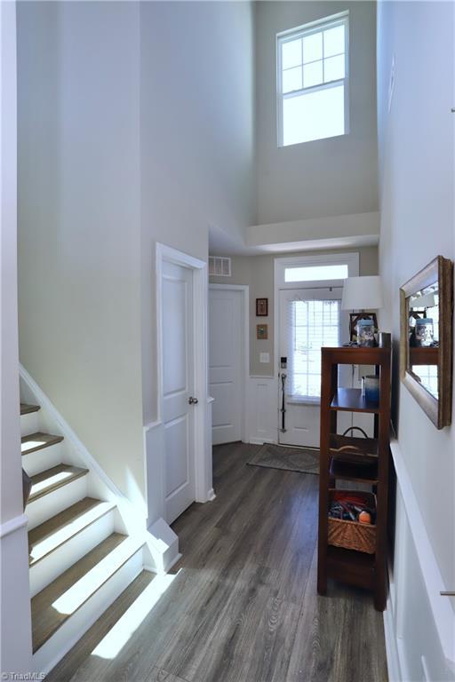 547 Historic Dr, Hillsborough, NC 27278 - entrance foyer featuring plenty of natural light, visible vents, a towering ceiling, wood finished floors, and stairway