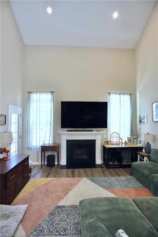 547 Historic Dr, Hillsborough, NC 27278 - living area featuring a fireplace, a high ceiling, wood finished floors, and recessed lighting