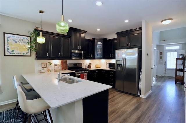547 Historic Dr, Hillsborough, NC 27278 - kitchen featuring dark wood finished floors, stainless steel appliances, a peninsula, glass insert cabinets, and a breakfast bar area