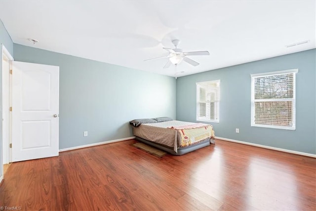 unfurnished bedroom featuring wood-type flooring and ceiling fan