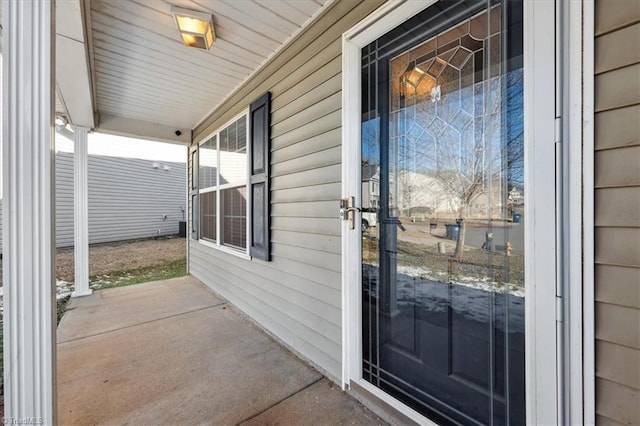 view of exterior entry with covered porch