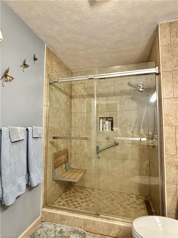 155 Page Farm Rd, Mount Airy, NC 27030 - bathroom featuring a stall shower, toilet, and a textured ceiling