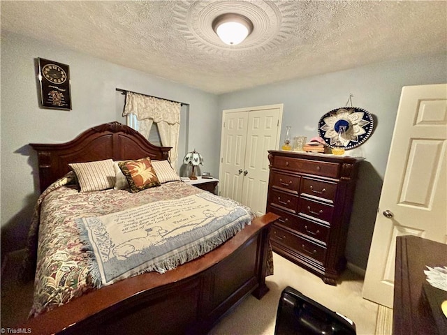 155 Page Farm Rd, Mount Airy, NC 27030 - bedroom featuring a closet, a textured ceiling, and light carpet