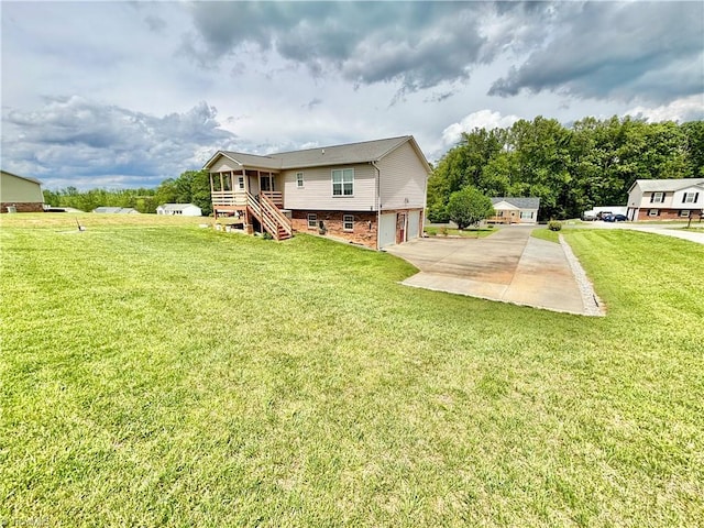 155 Page Farm Rd, Mount Airy, NC 27030 - back of property with an attached garage, a yard, concrete driveway, brick siding, and stairs