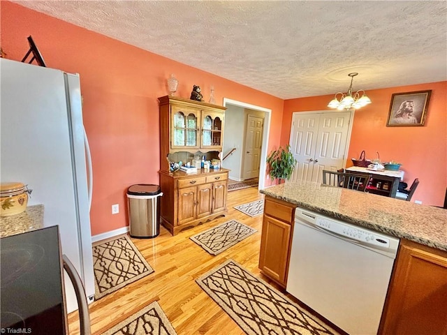 155 Page Farm Rd, Mount Airy, NC 27030 - kitchen featuring a notable chandelier, light wood-style floors, a textured ceiling, and white appliances