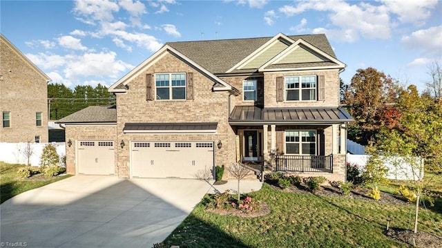 7722 NW Meadows Dr, Stokesdale, NC 27357 - craftsman inspired home with covered porch, concrete driveway, brick siding, a standing seam roof, and an attached garage