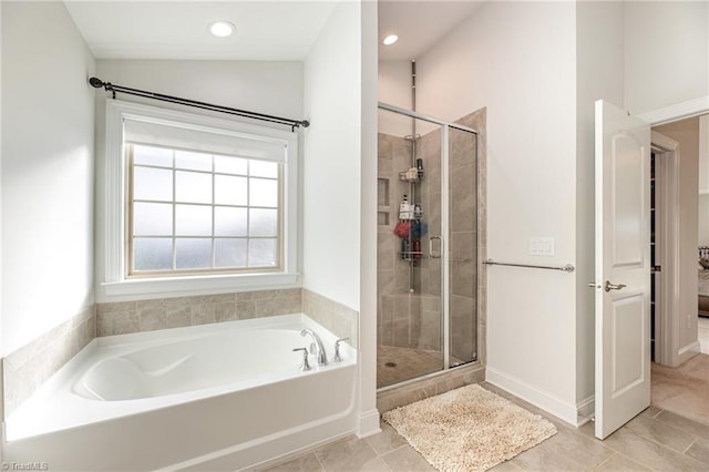 7722 NW Meadows Dr, Stokesdale, NC 27357 - bathroom featuring a garden tub, a shower stall, tile patterned flooring, and recessed lighting